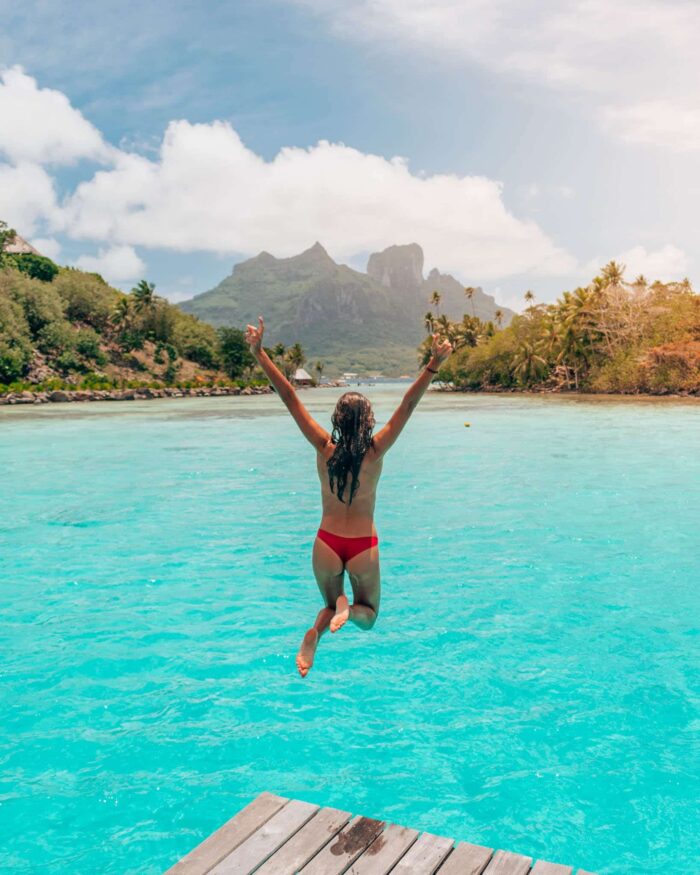 jump-mount-otemanu-conrad-bora-bora girl jumps in water at conrad bora bora nui