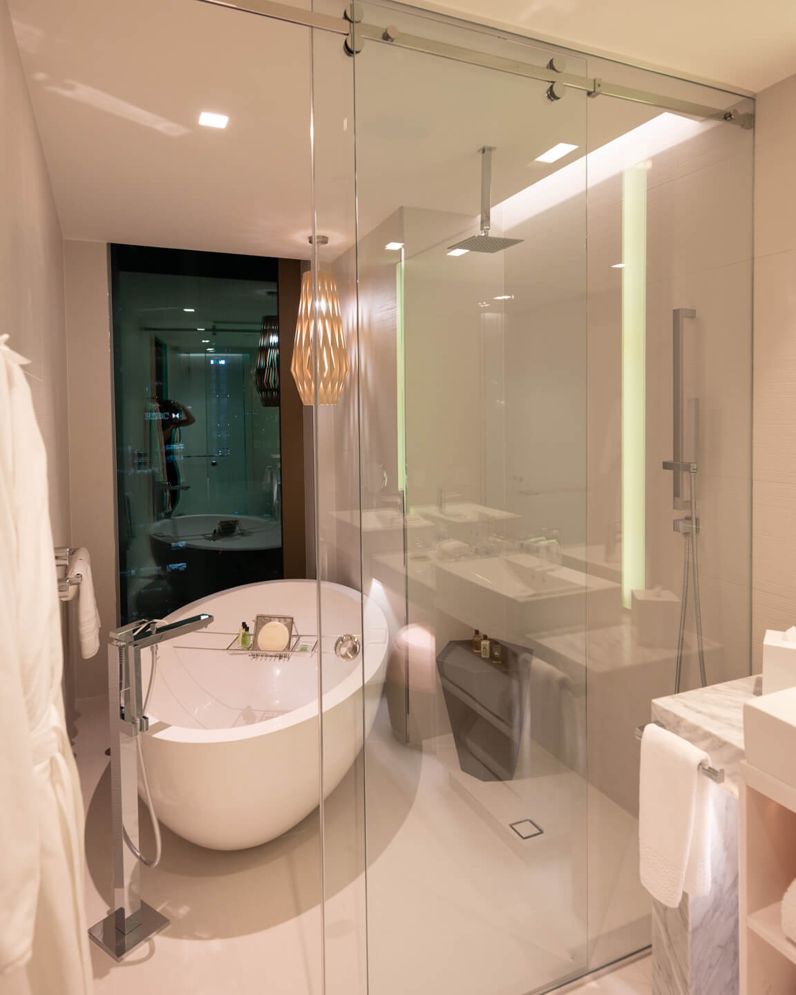 bathroom with marble and bathtub at a window