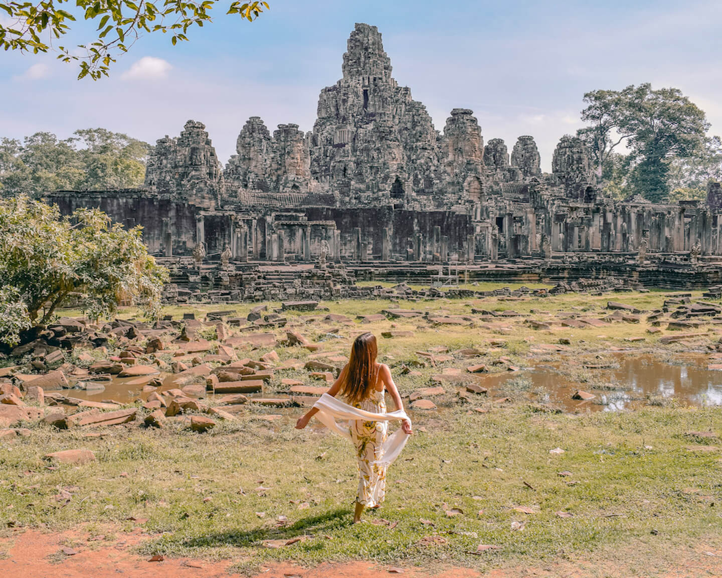 girl in front of Bayon temple ruins in Angkor