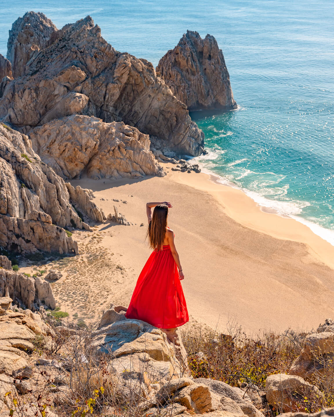 view over divorce beach from mount solar with girl in red dress