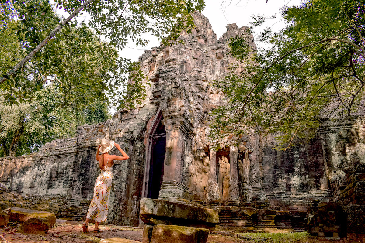 girl standing in fron of old ruin in Angkor Wat Cambodia